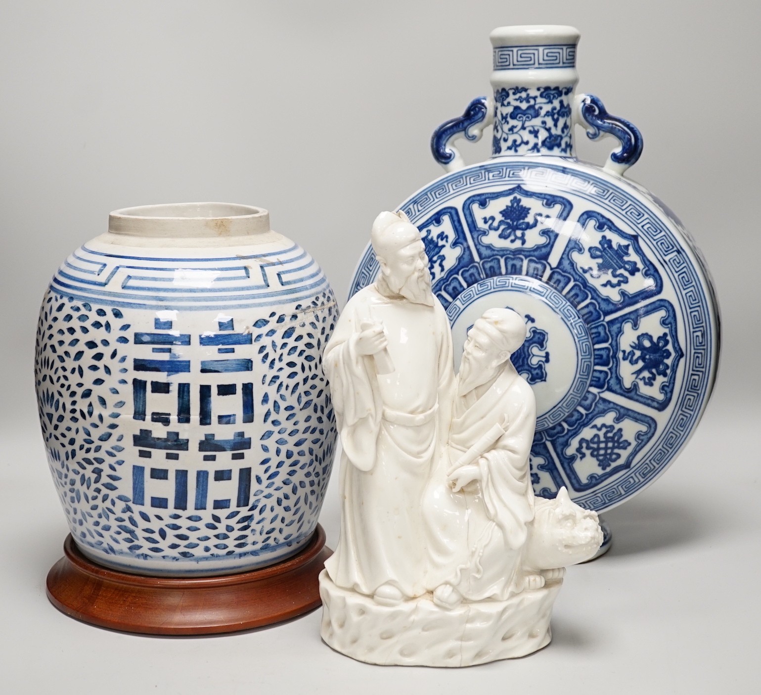 A Chinese blue and white two handled moonflask, together with another Chinese vase and Chinese figure group, tallest 36cm